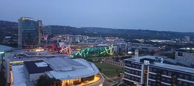 a view of a city at night with buildings at Menlyn Maine Trilogy Apartment 1518 in Pretoria