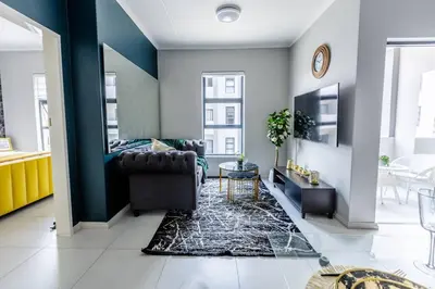 a living room with a couch and a table at Central Serenity @Midrand in Midrand