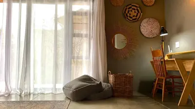 a room with a large window and a bean bag chair at The Lazy Leopard Lodge in Hoedspruit