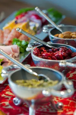 a table topped with bowls of food and spoons at umVangati House in Hoedspruit