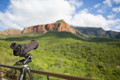 a camera on a tripod with a mountain in the background at umVangati House in Hoedspruit