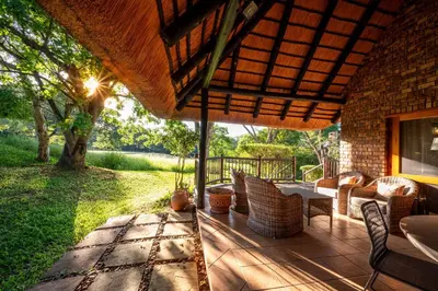 an outdoor patio with a table and chairs at Kruger Park Lodge Unit No. 246 in Hazyview