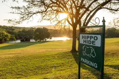 a sign for a hippo ride next to a tree at Kruger Park Lodge Unit No. 246 in Hazyview