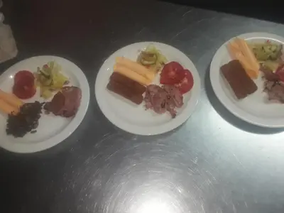 three plates with different types of food on them at Loding Lodge in Loding