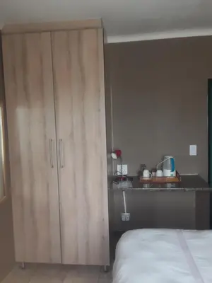 a bedroom with a large wooden cabinet next to a bed at Loding Lodge in Loding