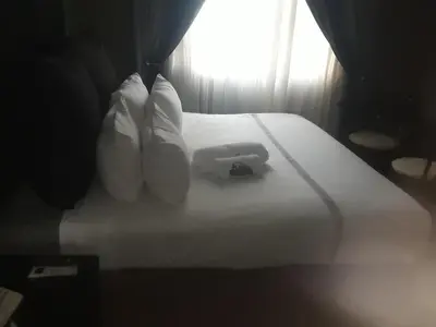 a bed with white pillows and towels on it at Loding Lodge in Loding