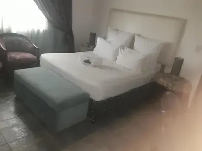 a hotel room with a bed and a chair at Loding Lodge in Loding