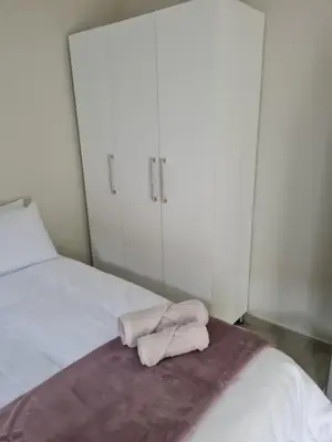 a bedroom with a bed with two towels on it at Lukhanyo Guest House in Northam