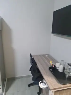 a table in a room with a desk with a tv at Lukhanyo Guest House in Northam