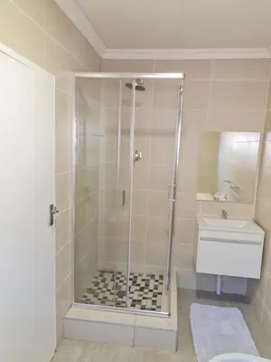 a bathroom with a shower and a sink at Lukhanyo Guest House in Northam