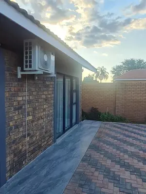 a brick house with a air conditioner on the side of it at Lukhanyo Guest House in Northam