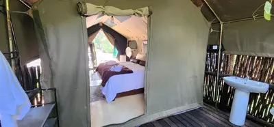 a inside of a tent with a bed and a sink at Tot Hier Toe in Phalaborwa