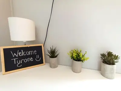 a shelf with potted plants and a chalkboard at OR Tambo Stay Unit 3 in Boksburg