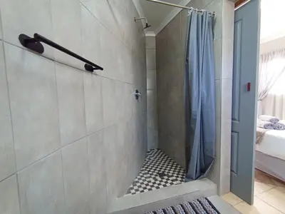a bathroom with a shower with a shower curtain at OR Tambo Stay Unit 3 in Boksburg