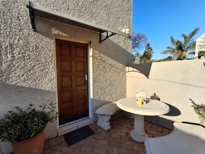 a table in front of a building with a door at OR Tambo Stay Unit 3 in Boksburg