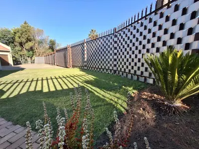 a retaining wall with a plant in a yard at OR Tambo Stay Unit 3 in Boksburg