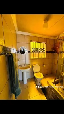 a small bathroom with a toilet and a sink at TSHABELANG MOUNTAIN VIEW LODGE in Burgersfort