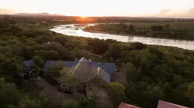 an aerial view of a house and a river at Tswenyane Kruger Lodge in Marloth Park