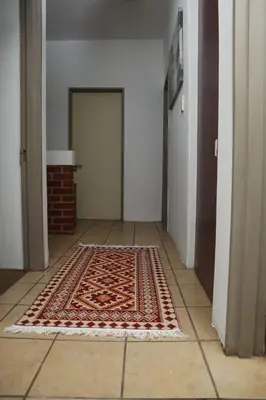 a hallway with a rug on the floor with a door at Spacious and luxury 3 bedroom apartment in Midrand