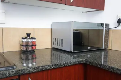 a microwave oven sitting on a counter in a kitchen at Spacious and luxury 3 bedroom apartment in Midrand
