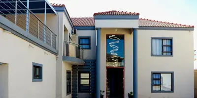 a building with a sign on the side of it at AZALEA LODGE in Midrand