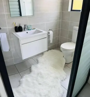 a bathroom with a white sink and a toilet at Large 3 Bedroom Apartment in Midrand, Waterfall City - More space than a hotel room - Ideal for families, groups and work trips - 19 Elizabeth Place in Midrand