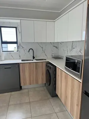 a kitchen with a sink and a microwave at Large 3 Bedroom Apartment in Midrand, Waterfall City - More space than a hotel room - Ideal for families, groups and work trips - 19 Elizabeth Place in Midrand