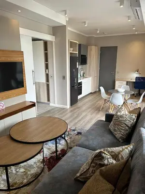 a living room with a couch and a table at Menlyn Maine Residences 1 bedroom Apartment 505 in Pretoria