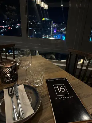 a wooden table with a plate and fork and knife at Menlyn Maine Residences 1 bedroom Apartment 505 in Pretoria