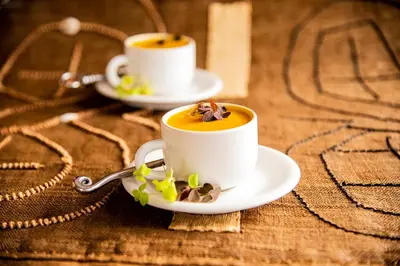 two cups of coffee on a wooden table at Makweti Safari Lodge in Welgevonden Game Reserve