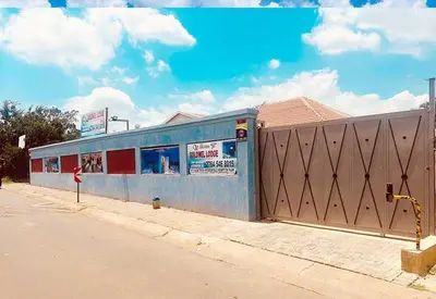 a blue building on the side of a street at Goldwell airport Lodge in Kempton Park