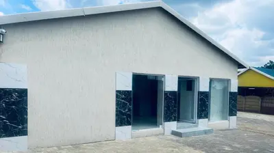 a white building with glass doors on it at Goldwell airport Lodge in Kempton Park