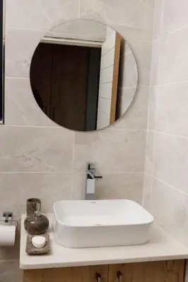 a bathroom with a white sink and a mirror at Uptown Apartments - Garden Pavillion in Nelspruit