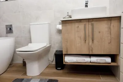 a bathroom with a white toilet and a sink at Uptown Apartments - Garden Pavillion in Nelspruit