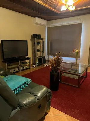 a living room with a couch and a flat screen tv at Lizpeter guest house in Elim