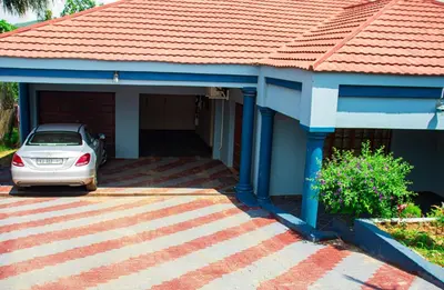 a car parked in front of a house at Lizpeter guest house in Elim