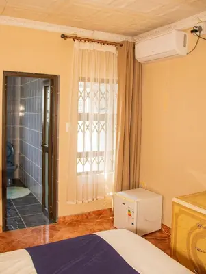 a bedroom with a bed and a window at Lizpeter guest house in Elim