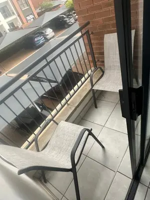 two chairs sitting on top of a balcony at One Bedroom The Blyde in Pretoria