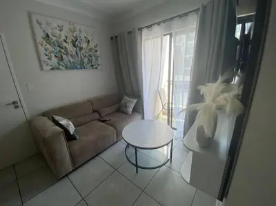 a living room with a couch and a table at One Bedroom The Blyde in Pretoria