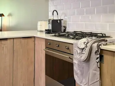 a kitchen with a stove with a towel on the oven at Seed @Colette in Pretoria
