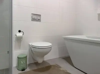 a white bathroom with a toilet and a sink at Seed @Colette in Pretoria