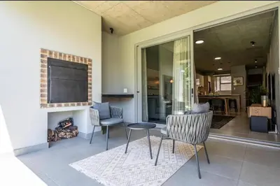 a living room with chairs and a fire place at Seed @Colette in Pretoria