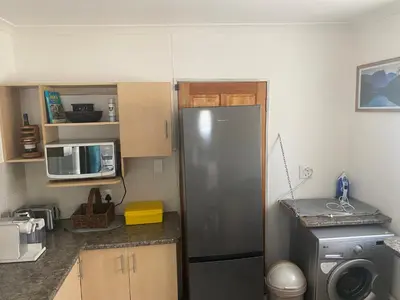 a kitchen with a refrigerator and a microwave at Mamuka Africa in Midrand