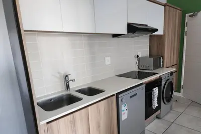 a small kitchen with a sink and a dishwasher at 297 The Blyde Crystal Lagoon in Pretoria
