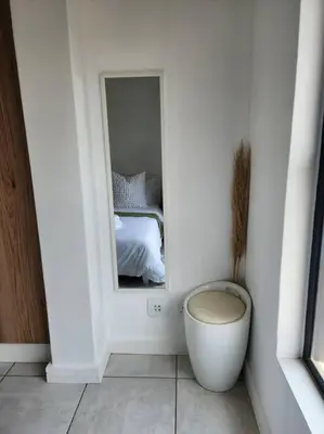 a white room with a mirror and a bed at 297 The Blyde Crystal Lagoon in Pretoria