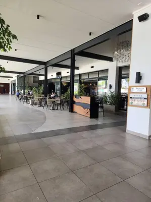 a large building with tables and chairs in it at 297 The Blyde Crystal Lagoon in Pretoria