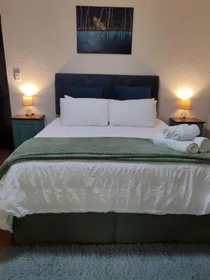 a bedroom with a large bed with two towels on it at Serendipity in Kampersrus AH