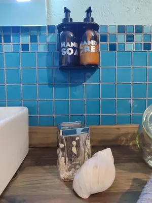 a cutting board with a bottle of honey and a garlic at Serendipity in Kampersrus AH