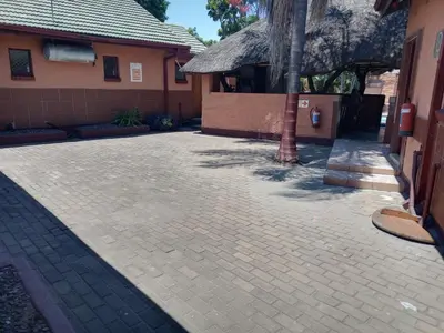 a brick driveway in front of a house at Butterfly tree guesthouse in Phalaborwa