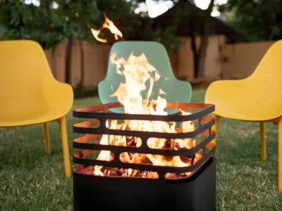 a fire pit in a yard with two chairs at Brooklyn Blok in Pretoria